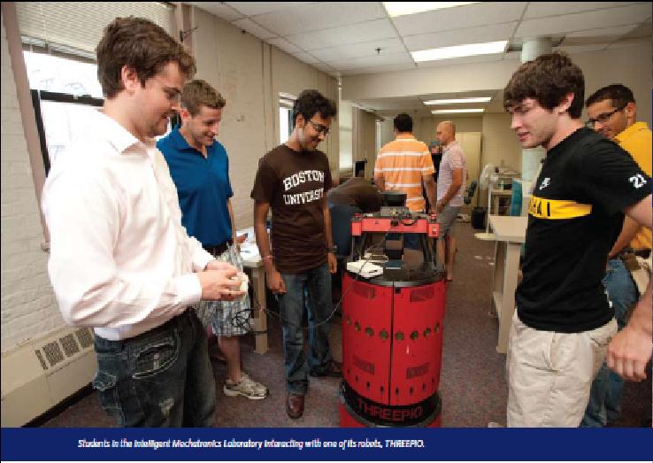 With peers in the Boston University Intelligent Mechatronics Laboratory, interacting with the lab's mobile robot 'THREEPIO'.